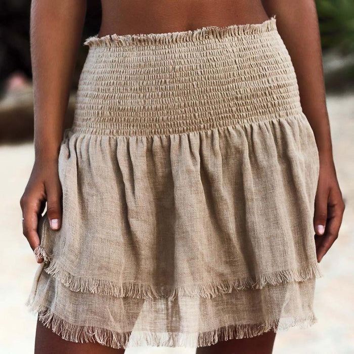 A woman in a Fringed Summer Cotton Beach Shorts by Beachy Cover Ups enjoying the beach during summer.