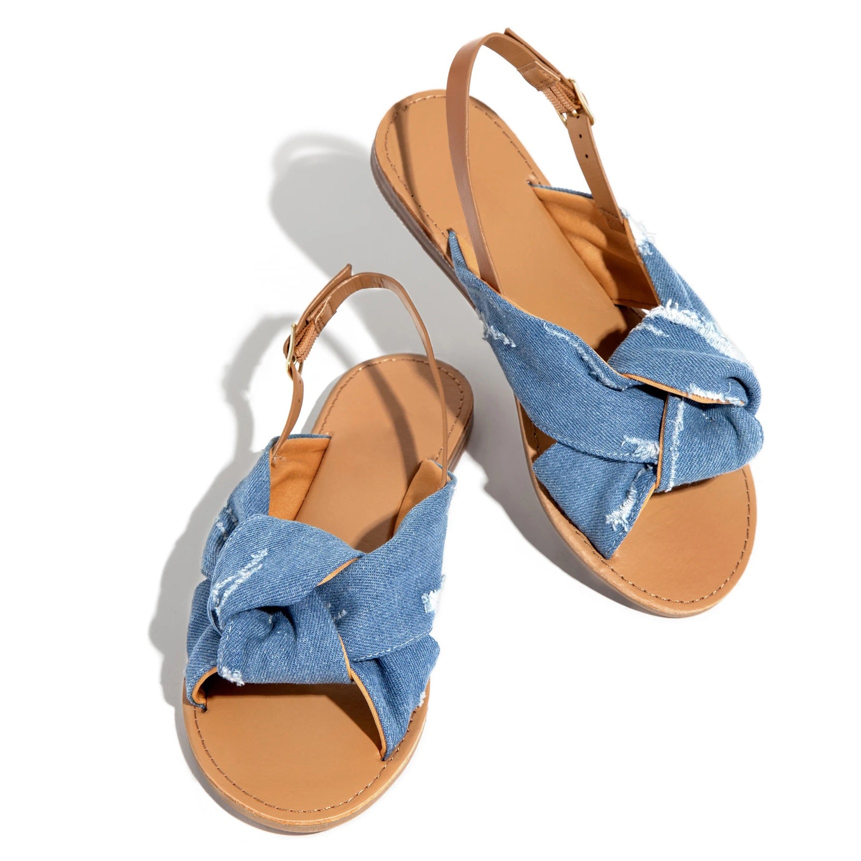 A pair of Ribbon Tie Flat Sandals Beach Slippers with a knotted strap, perfect for coastal elegance by Beachy Cover Ups.