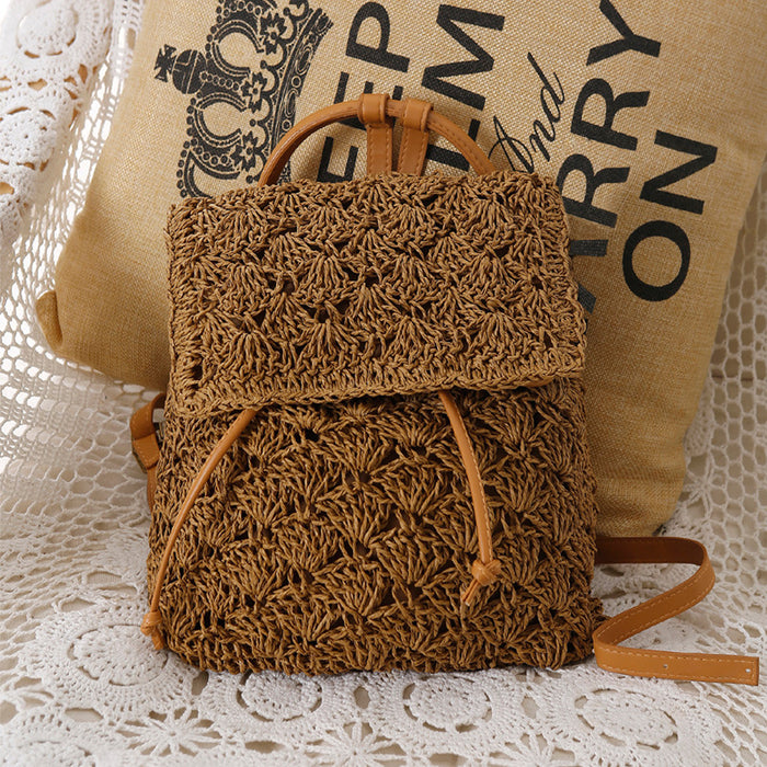 A small Resort Holiday Straw Woven Beach Bag by Beachy Cover Ups sitting on top of a pillow.