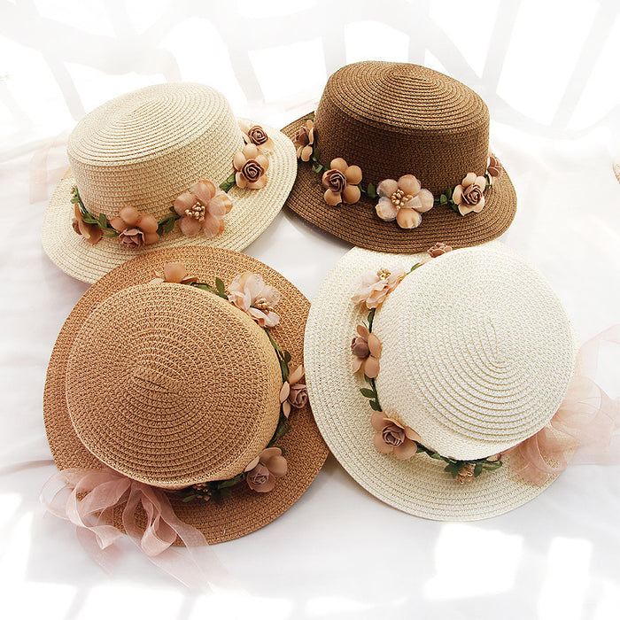 Three Beachy Cover Ups wide brim Flower Designed Beach Hats adorned with flowers on top of a bed.