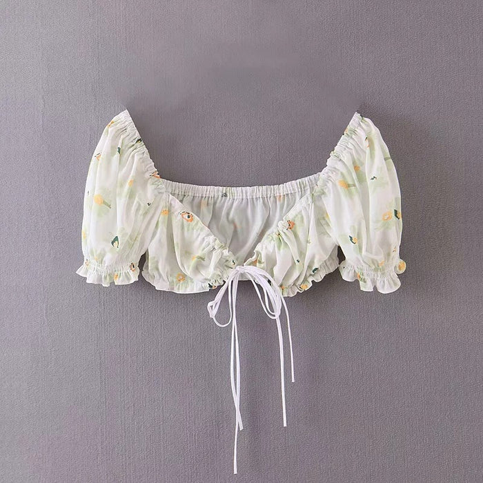A Beach Vacation Print Two Piece Set in the brand Beachy Cover Ups hanging on a gray wall, essential for beachgoers or fashion-conscious individuals seeking a standout piece in their vacation wardrobe.