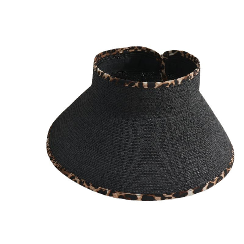 A black hat with leopard print trim and Big Brim Cheetah Print Edge Straw Visor brand.
