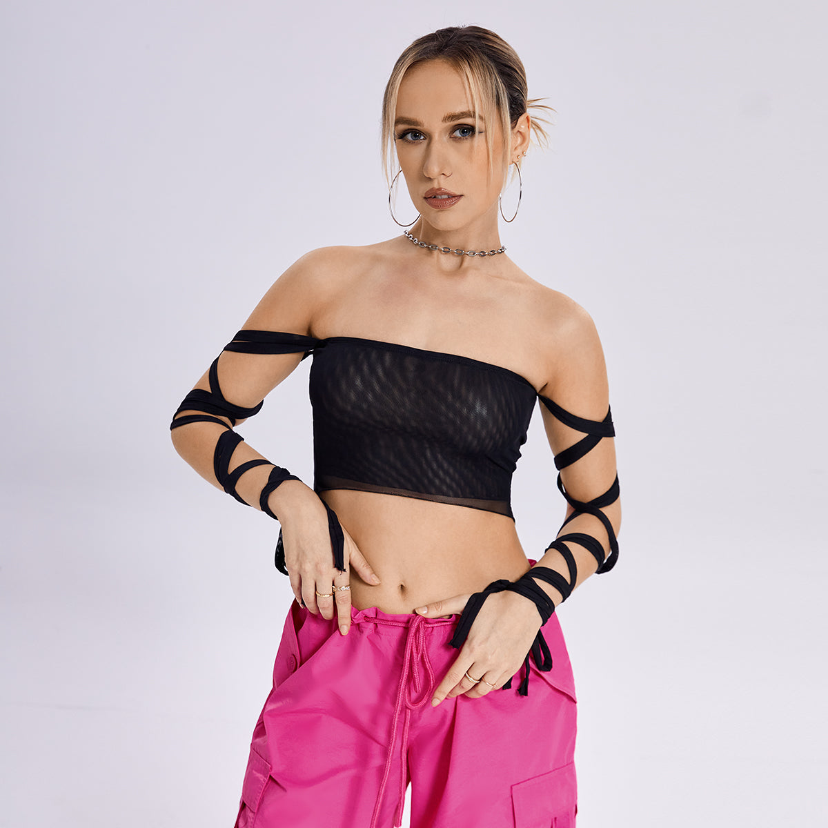 The model is wearing a fashion-forward Beachy Cover Ups Arm Ribbon Straps Black Top design.
