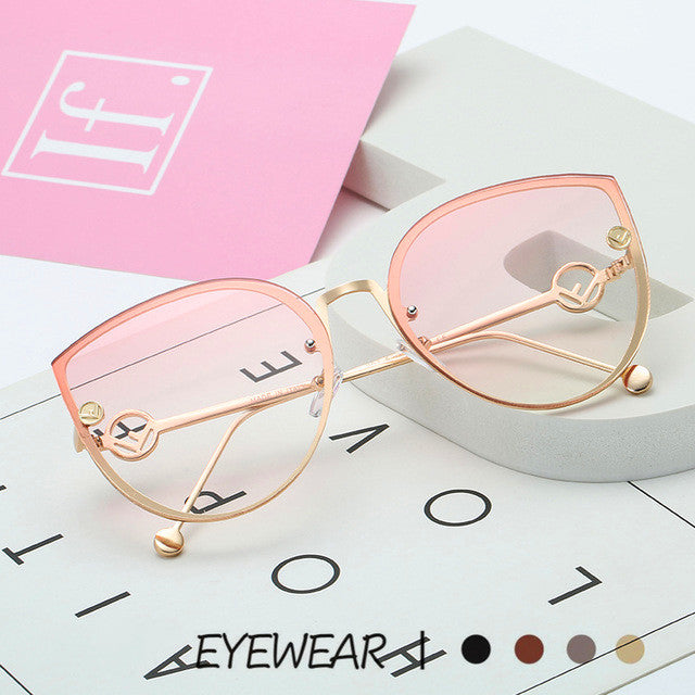 A pair of Rimless Teardrop UV Sunglasses with a pink frame and UV protection by Beachy Cover Ups.
