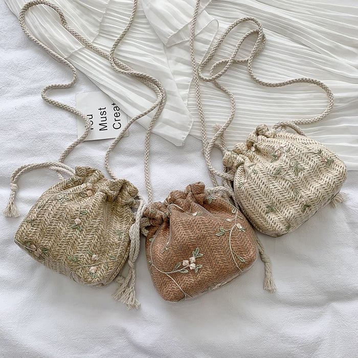 Three Floral Lace Vacation Beach Bags with a touch of lace on a white bed. (Brand Name: Beachy Cover Ups)