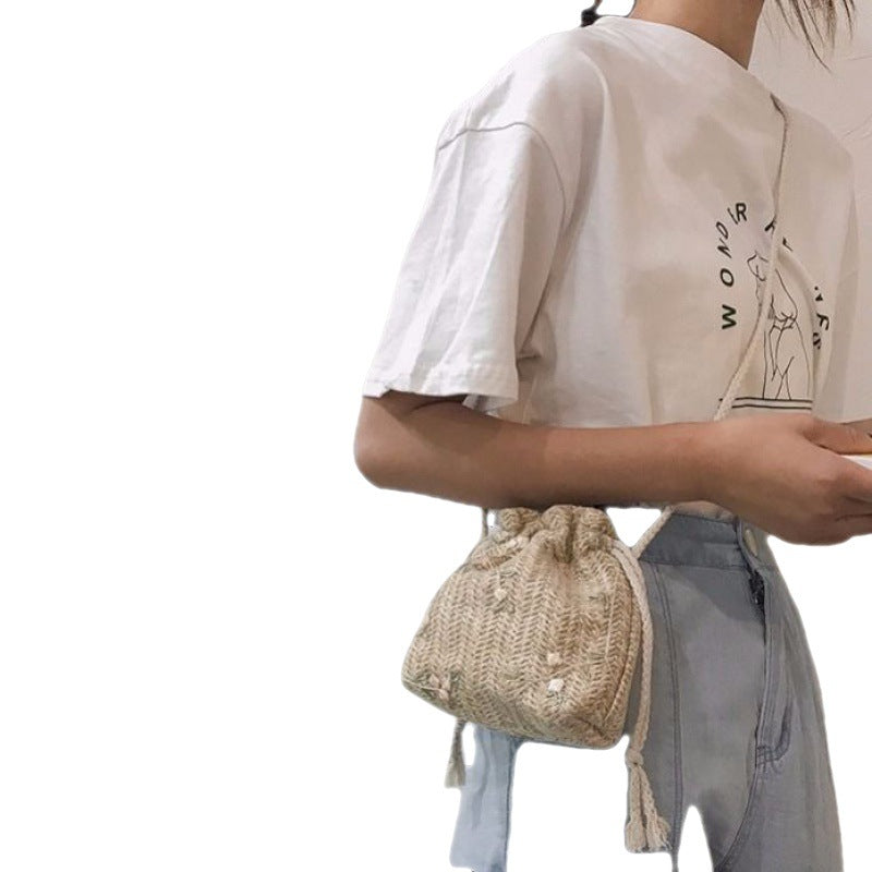 A woman with urban simplicity holding a Floral Lace Vacation Beach Bag by Beachy Cover Ups.