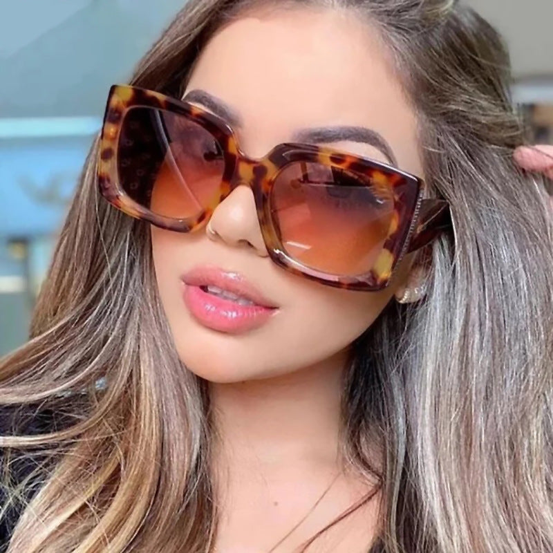 A woman wearing a pair of Beachy Cover Ups Trendy Large Frame Sunglasses.